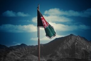Flag of Afghanistan against a dark landscape