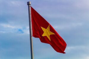 Flag of Viet Nam gently blowing against a cloudy sky