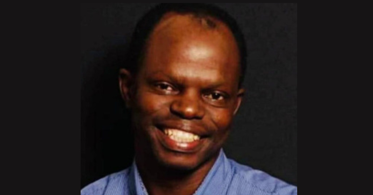 This is a portrait photograph of Thulani Maseko, looking at the camera and similing.