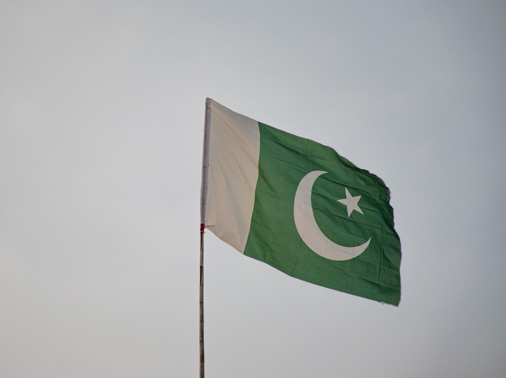 Flag of Pakistan against a grey sky