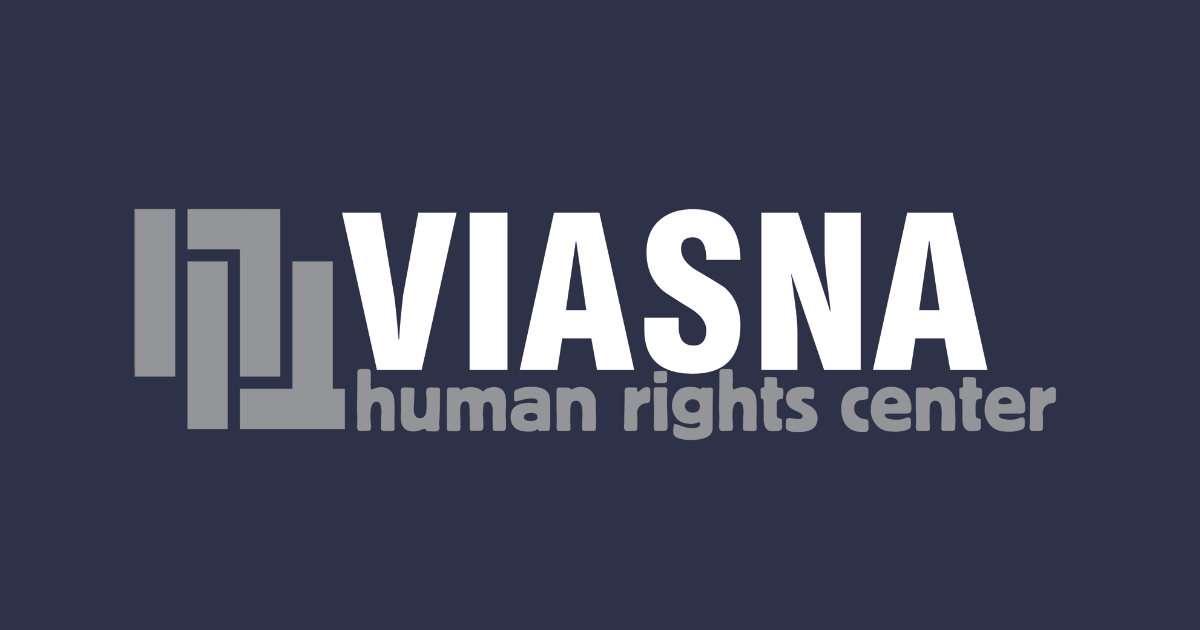 The logo of Viasna made of rectangular shapes on a dark, greyish purple background. 'Viasna' is written in all-caps white letters, underneath which one can read 'human rights center' in lower caps grey letters.