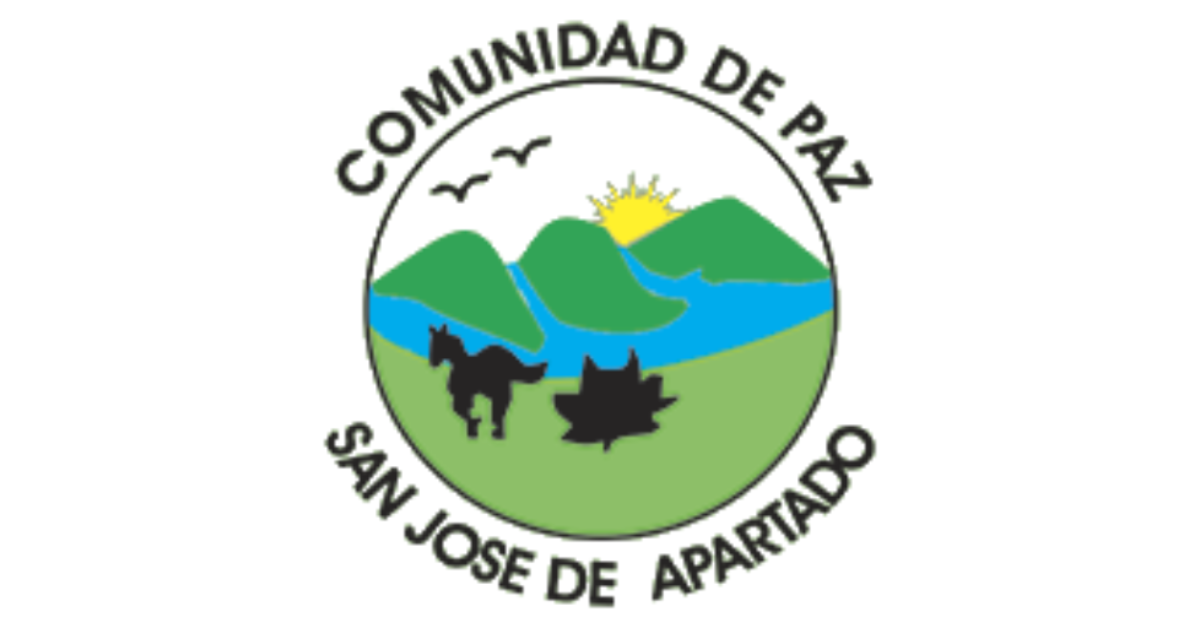 Logo of the Peace Community of San José de Apartadó, a Colombian campesino initiative bound together by the ethics of nonviolence and solidarity. The circular logo displays a blue river flowing between green hills, with the silhouettes of a horse and a leaf in the foreground, birds flying in the sky and a yellow sun peeking through the hills. Around the logo is written Comunidad de paz, San José de Apartado in capital black letters.