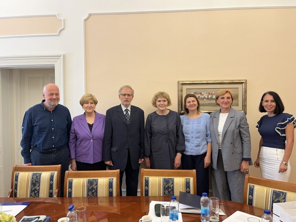 Mary Lawlor, UN Special Rapporteur on human rights defenders, stands with members of the Constitutional Court of Bosnia and Herzegovina and the Court’s secretariat during her official visit. They are gathered indoors in a formal meeting room, standing in front of a framed painting, with a conference table and documents visible in the foreground.