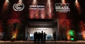 Silhouettes of people gathering around the entrance to the COP30 venue in Belém, in the Brazilian Amazon. (Photo: © UN Climate Change - Kiara Worth, shared on Flicker under CC BY-NC-SA 4.0 licensing)